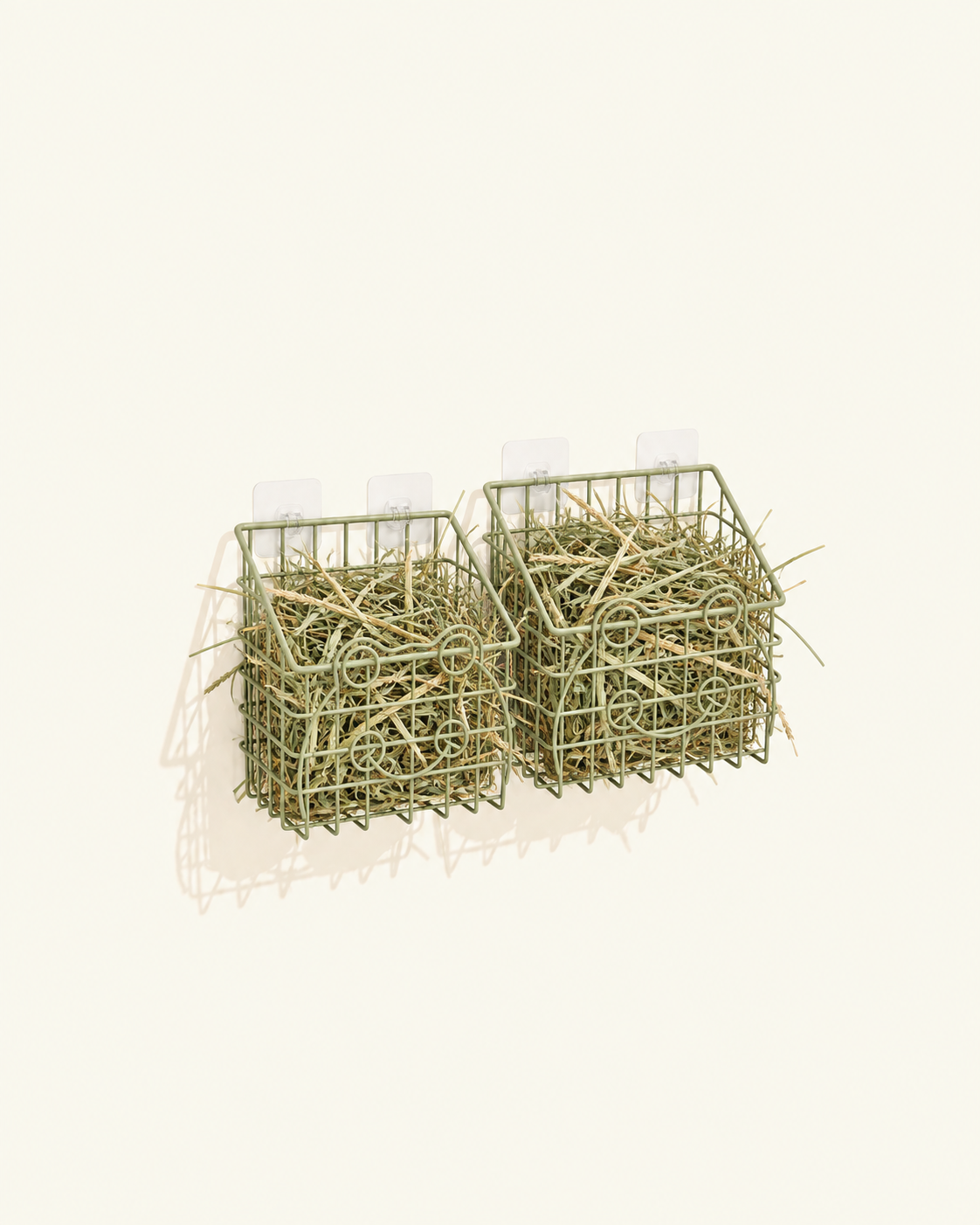 Two olive green metal wire hay holders filled with hay